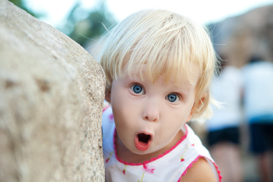 surprised girl by the stone
