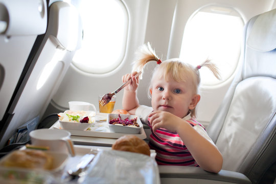 girl eating in the airplane