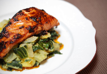 Salmon filet on bed of swiss chard and potatoes - 49556015