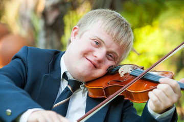 Portrait of young handicapped violinist.
