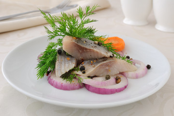 Slices of salted herring with onions and spices