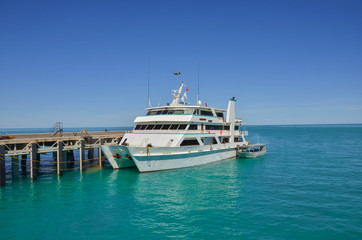 Fototapeta premium Catamaran Moored at a Jetty and Blue Sky