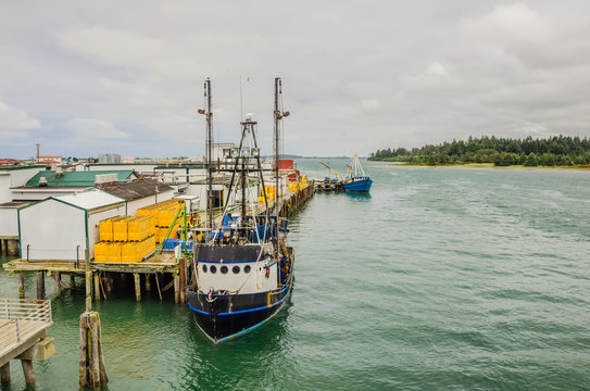 Fishing Boats Being Unloaded and Cloudy Sky