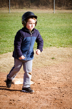 Boy running bases at t-ball practice