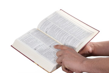 Praying hand hold an open bible