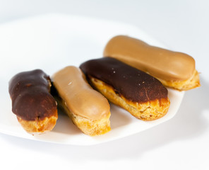 Cakes an eclair on a saucer