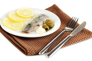 Dish of herring and lemon on plate isolated on white