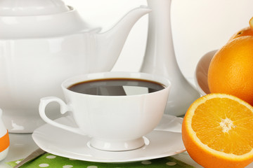Beautiful white dinner service with oranges isolated on white