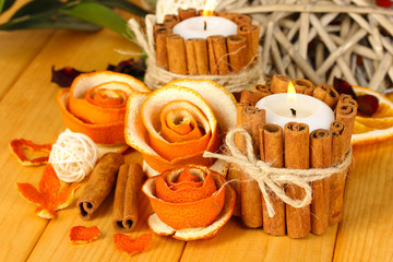 Decorative rose from dry orange peel and burning candles