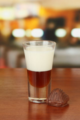 Tasty cocktail with two liquors, on bright background