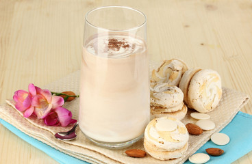 Glass of chocolate-cream cocktail on wooden table close-up