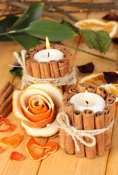 Decorative rose from dry orange peel and burning candles