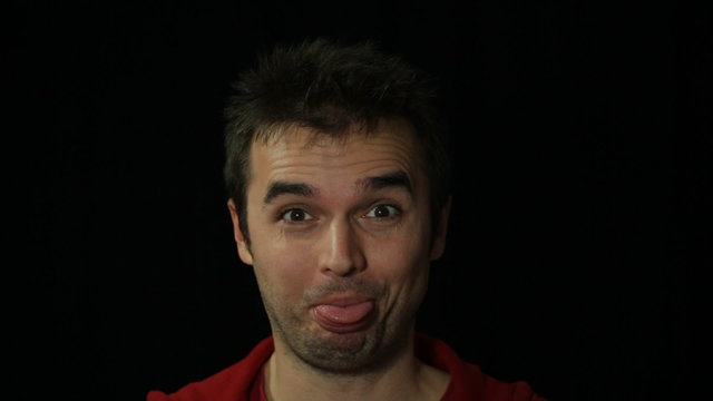 Man making funny faces, studio isolated