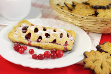 Cake with cranberries on decorated table