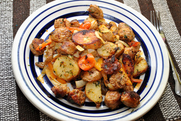 Fried Sausage and Potatoes Served on a White Plate