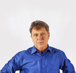 Obraz premium Portrait of a confident senior man standing on white background