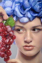 beautiful young girl with red grapes