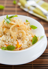 risotto with pumpkin in a white bowl