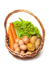 carrot, eggs, onion, poatatoes in a basket