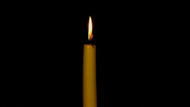 Burning-down yellow candle. Time lapse