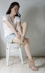 portrait of woman suffer from pain of high heeled shoes