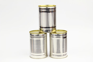 Unopened cans arranged on the white background