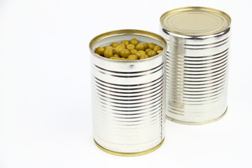 The tins with peas on the white background