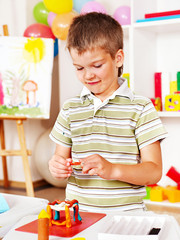 Child painting at easel.