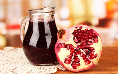 Full jug of pomegranate juice,on wooden  table