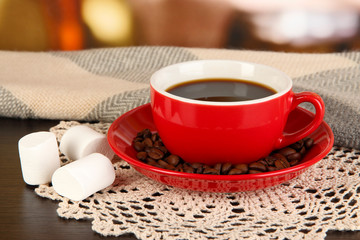 cup of coffee with scarf on table in room