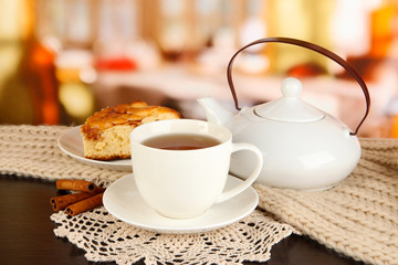 cup of tea with scarf on table in room