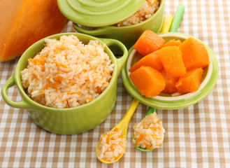 Taste rice porridge with pumpkin in saucepans