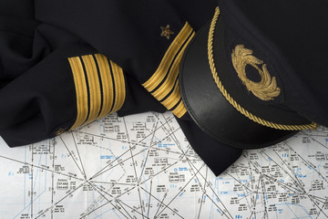 captain uniform over an aeronautical navigation chart