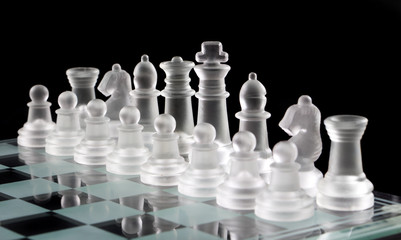 Chess board and chess pieces isolated on black