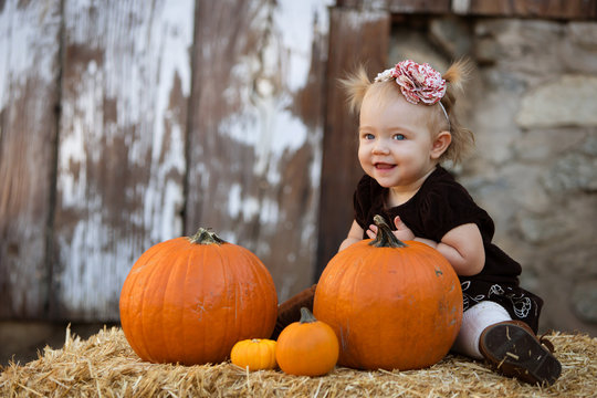 Happy toddler with pumpkin