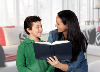 Mother teaching her child to read .