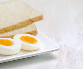 Boiled egg and toasts on white plate