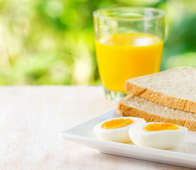 Boiled egg, toasts and orange juice.