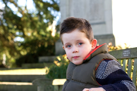 young boy staring ahead with emotion on face