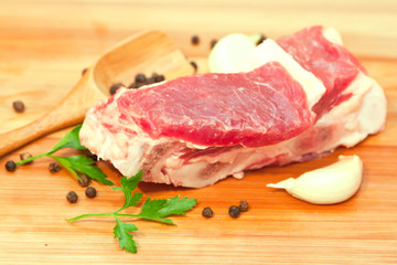 Raw beef with spices and vegetables on the cutting board