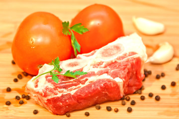Raw beef with spices and vegetables on the cutting board