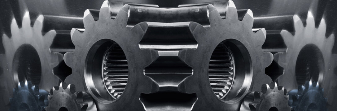 gears and cogwheels panoramic mirror image in blue toning