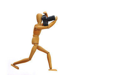 Wooden figure taking photos with camera