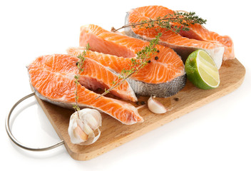 Raw trout steaks on cutting board isolated on white