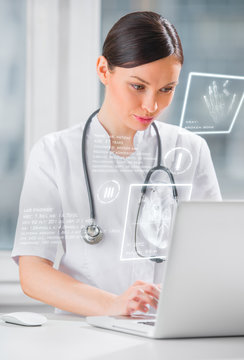 Pretty female medicine doctor working with modern computer inter