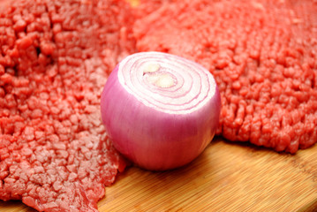 A Red Onion with Raw Cube Steaks