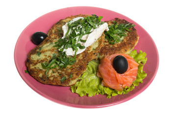 Roasted cutlets of potato with salmon on a plate