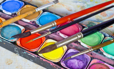 artist toolbox and paint brushes