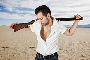 man with gun in desert