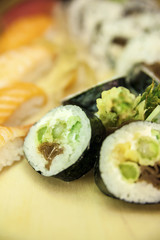 Futomaki Asparagus and blurred Nigiri and California Roll